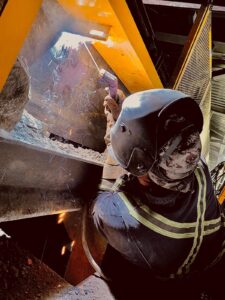 Welder Worker welding a metal plate