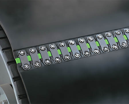 Belt Fasteners Flexco Green Viacore background with a man supervising packages on a conveyor belt