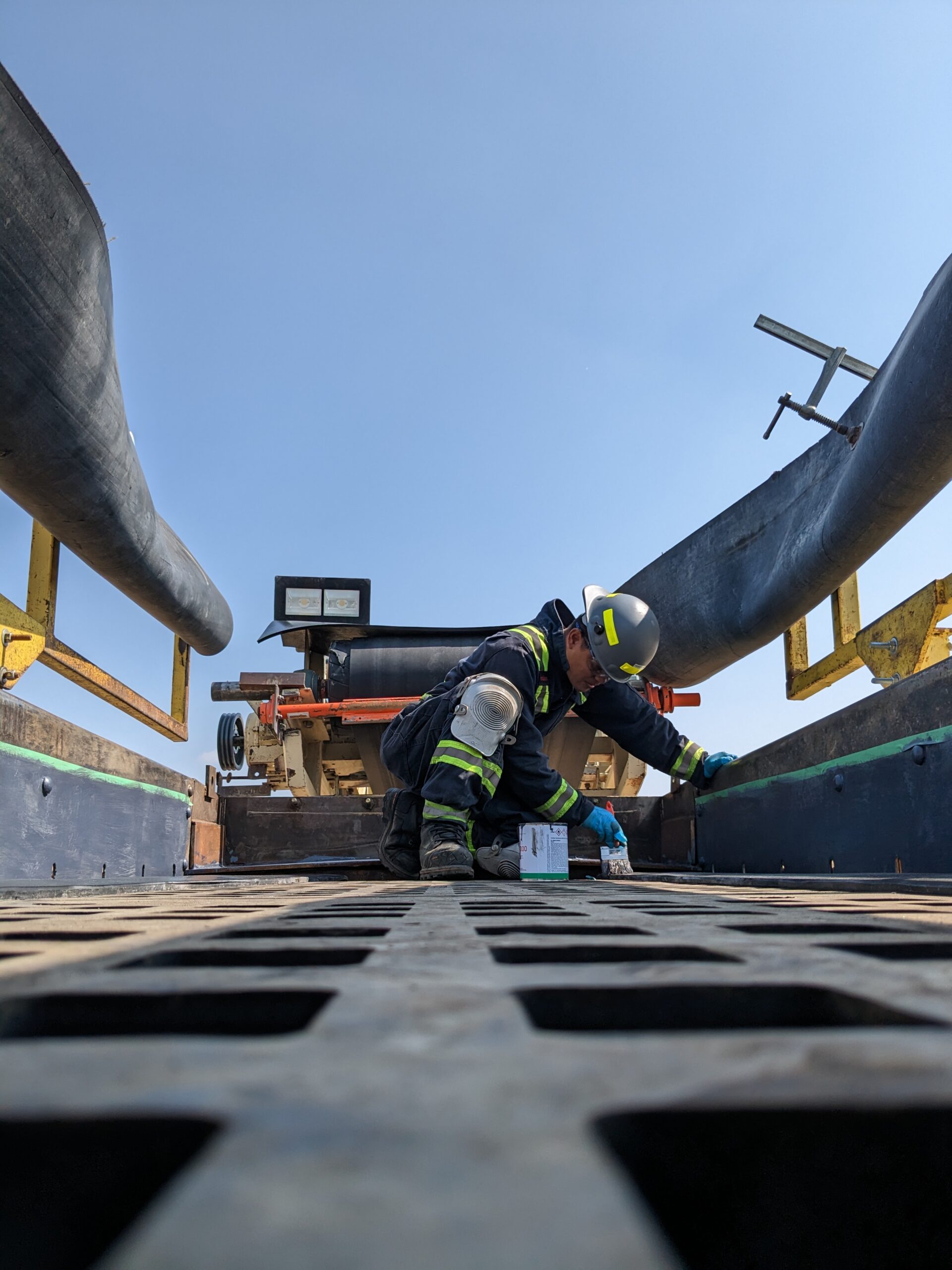 Viacore worker using a milter saw to cut wood