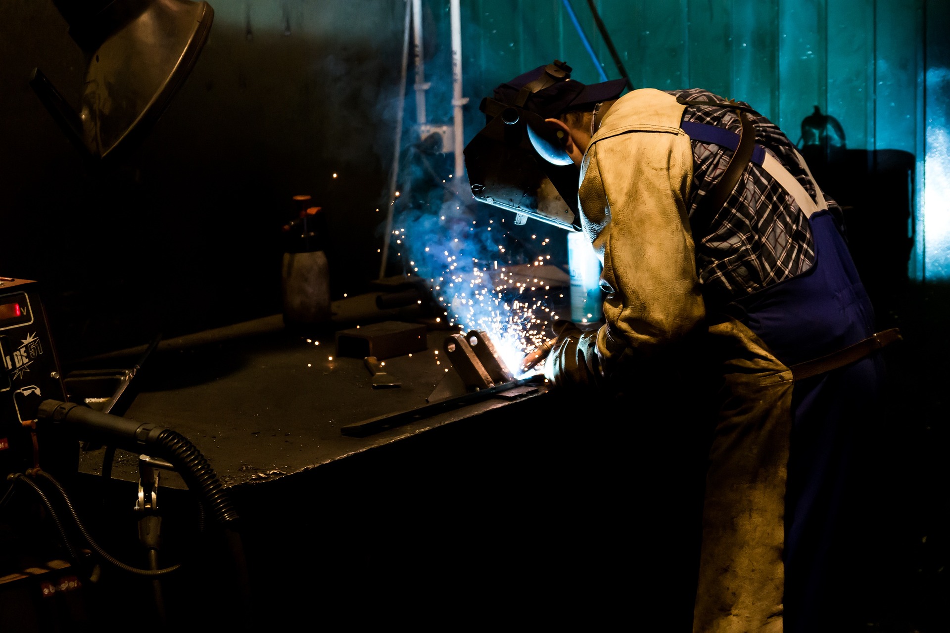 A worker performing conveyor belt maintenance