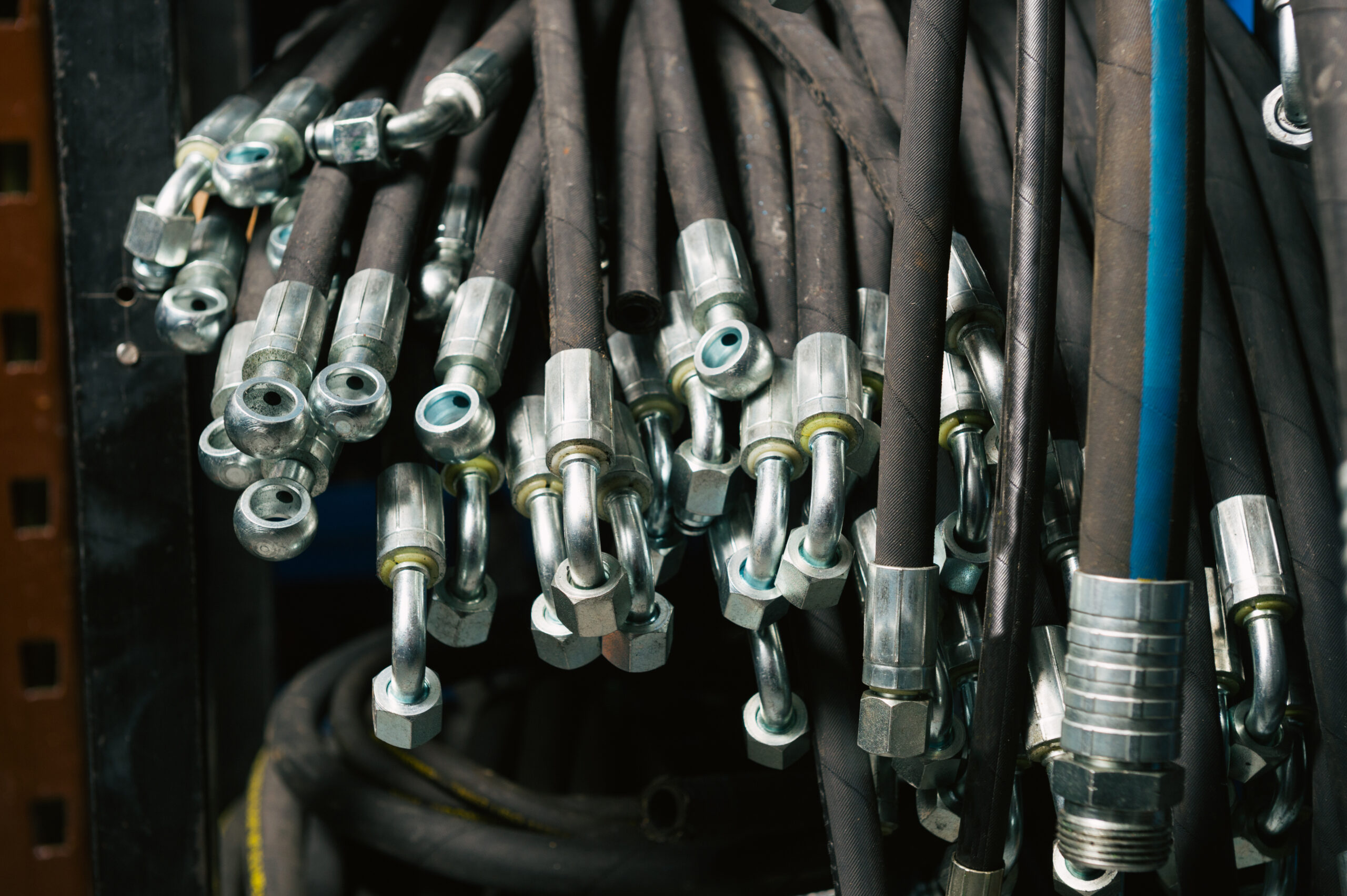 A worker attaches cables for the installation of a conveyor belt at an oil facility